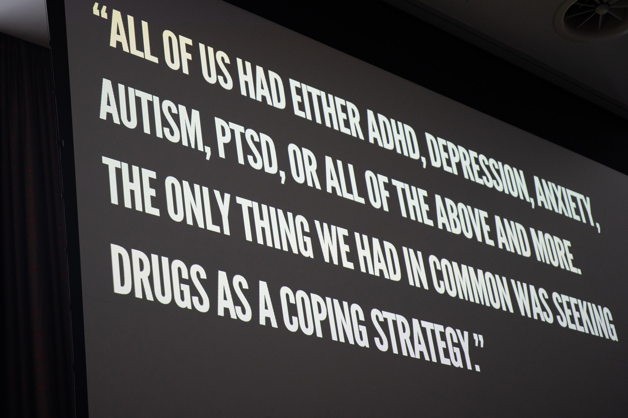 Greyscale photo taken at HIT Hot Topics 2025 of a quote from BRP's 2022 research which reads: All of us had either ADHD, depression, anxiety, autism, PTSD, or all of the above and more. The only thing we had in common was seeking drugs as a coping strategy.